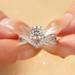Moissanite sterling crossover ring with pavé band and solitaire center stone.