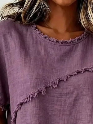 Purple crew neck shirt with frayed asymmetrical hem and neckline detail.