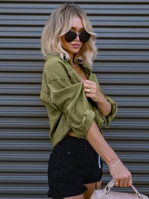 Cropped utility shirt in matcha green cotton with drawstring waist and rolled sleeves.