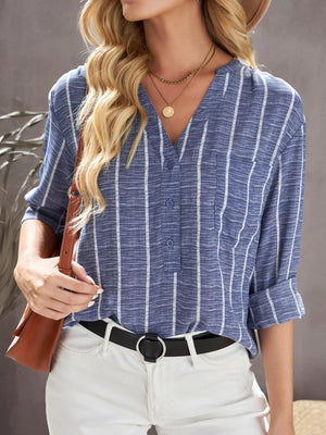 Dusty blue striped V-neck buttoned blouse with a chest pocket and rolled sleeves.
