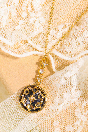 Gold celestial medallion pendant necklace with moon phases and stars, on a delicate chain.