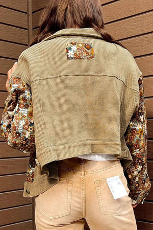 Khaki waffle knit jacket with floral print sleeves and back panel detail.