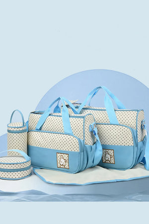 Pastel blue and white polka dot diaper bag set with bunny embroidery and changing mat.