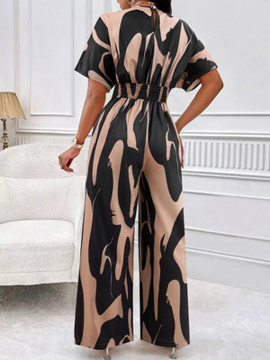 Black and beige abstract print wide-leg romper with short sleeves and elastic waist