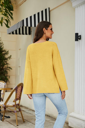 Yellow relaxed fit v-neck knit pullover sweater with long sleeves and ribbed hem.