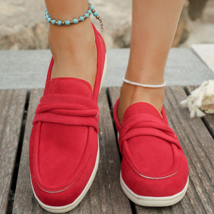 Red slip-on loafers with a round toe and knotted detail.