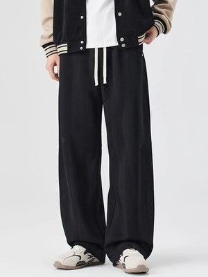 Black jogger sweatpants with white drawstring and a relaxed fit.