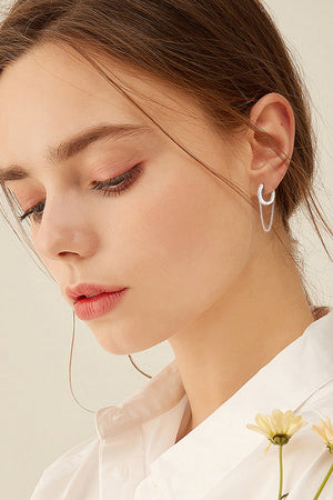 Silver dangling chain pavé huggie earrings with delicate sparkle