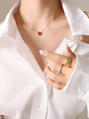 Crimson heart pendant necklace on rose gold chain, 18K gold detail, worn with white shirt
