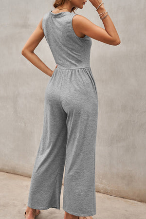 Gray gathered waist wide leg jumpsuit with pockets and a sleeveless, high neck.