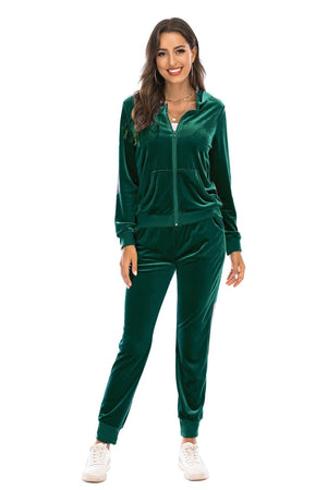 Green velvet loungewear set with zip-up hoodie and joggers, featuring white side stripe detail.