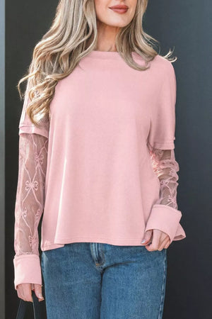 Pink maternity t-shirt with lace sleeves featuring bow details and a crew neckline.