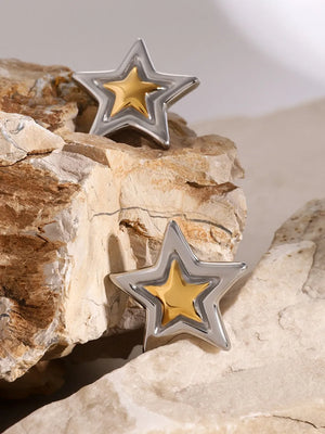 Sculpted starburst stud earrings in silver and gold feature a layered star design.