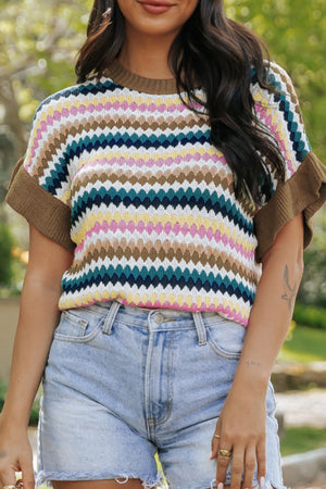 Textured knit sweater with colorful diamond pattern and contrast trim sleeves and neckline.