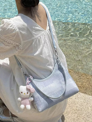 Blue pu leather shoulder bag with a textured finish and Hello Kitty charm.