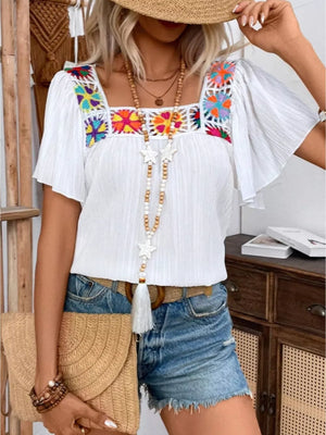 White embroidered square neck blouse with flutter sleeves and colorful floral detail