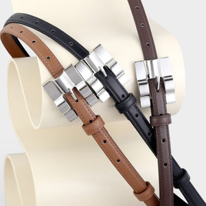 Slim cowhide leather belts in black, brown, and coffee brown with silver buckles.
