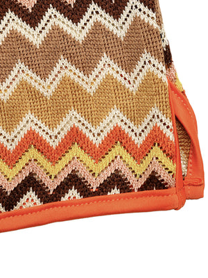Zigzag knit two-piece set with orange trim and crochet detail.