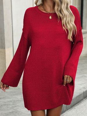 Oversized red ribbed knit tunic sweater with crew neck and bell sleeves.