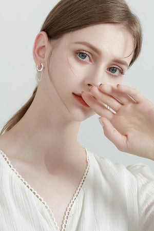 Silver dangling chain pavé huggie earrings with delicate sparkle