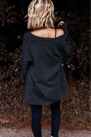 Dark gray open-knit pocket cardigan with cable knit detail on sleeves and sides.