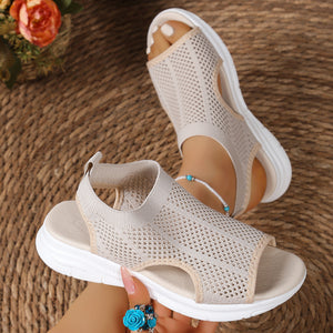 Beige mesh open-toe sandals with a chunky sole and comfortable fit.