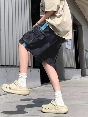 Black denim cargo shorts with blue braided drawstring detail and utility pockets.