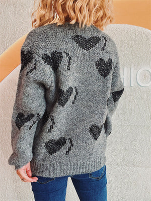 Dark gray acrylic knit cardigan with black sequin heart motif and button front.