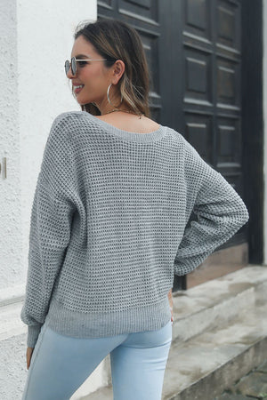 Dark gray waffle knit sweater with crew neck and long sleeves.