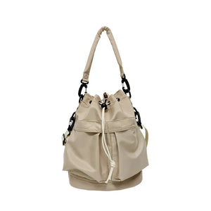 Beige nylon drawstring bucket bag with chain detail and top handle