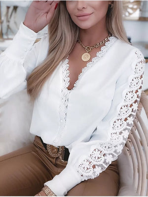 White lace-trimmed V-neck blouse with button cuffs and sheer lace sleeves.