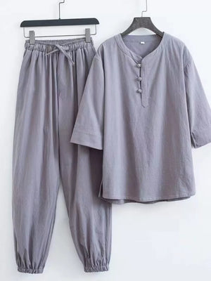Gray relaxed fit Chinese-inspired men's pants set with drawstring waist and button-up top.