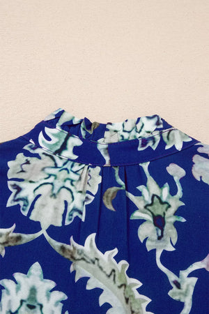 Maxi dress with vibrant floral print, frilled collar, and buttoned neckline.