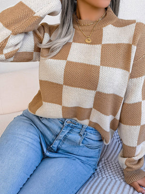 Checkerboard knit mock neck pullover in camel and white with long sleeves.