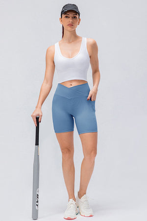 Light Blue cross-waist active bike shorts with pockets and a ribbed texture.