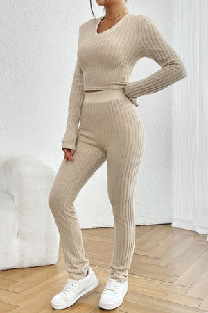 Beige ribbed knit co-ord set with v-neck crop top and high-waisted leggings.