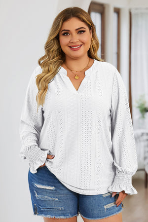 White textured blouse with slit neck and shirred cuffs.