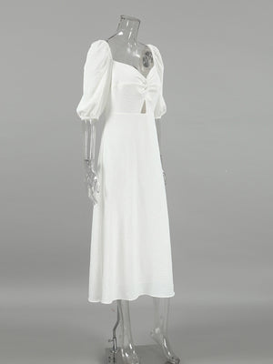 White midi dress with sweetheart neckline, puff sleeves, cutout detail and twisted front.