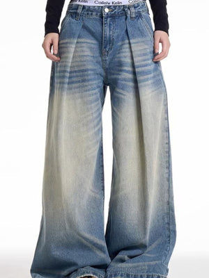 Men's wide leg blue washed denim jeans with a baggy fit and gradient fade.