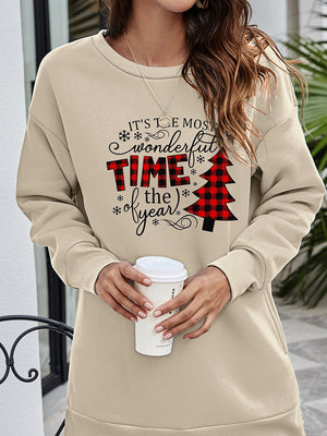 Beige tunic sweatshirt with holiday graphic and buffalo plaid Christmas tree detail.
