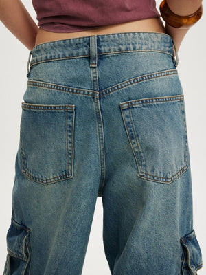 Relaxed fit cargo maternity jeans in light blue wash denim with vintage detailing.