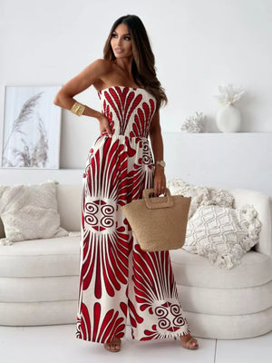 Strapless wide-leg romper in cream with red tribal print, smocked bodice, and wide legs.