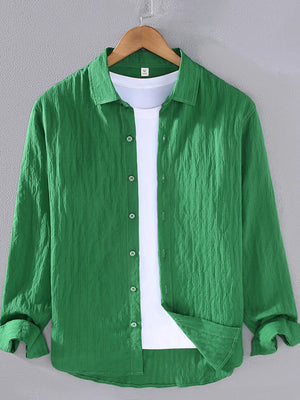 Green textured long sleeve button-up overshirt with classic collar and white t-shirt underneath.