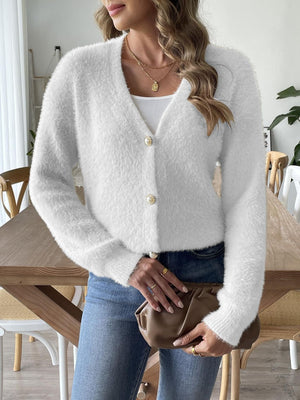 White plush button-down cardigan with pearl details and V-neck.