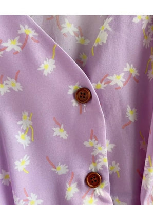 Violet floral v-neck midi dress with button detail and belted waist.