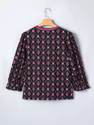 Black cotton blouse with vintage floral print, bracelet sleeves, and contrast trim neckline.