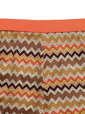 Zigzag knit two-piece set with orange waistband and multicolor chevron pattern.