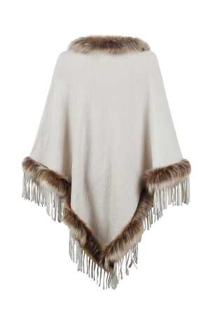 Ivory textured knit poncho with faux fur trim and fringe details.