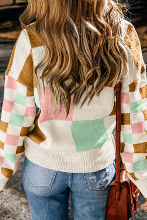 Colorblock checkerboard knit sweater with blush pink, beige, and mint green squares.