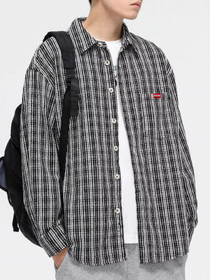Classic plaid button-up shirt with pocket in black and white, featuring a chest pocket.